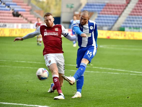 Joe Garner gets a shot away against Northampton