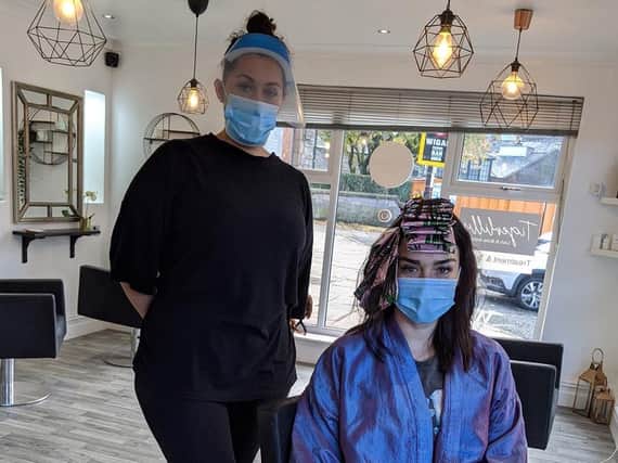 Claire Bailey, owner of Hair Envy on Bishopgate, with a customer