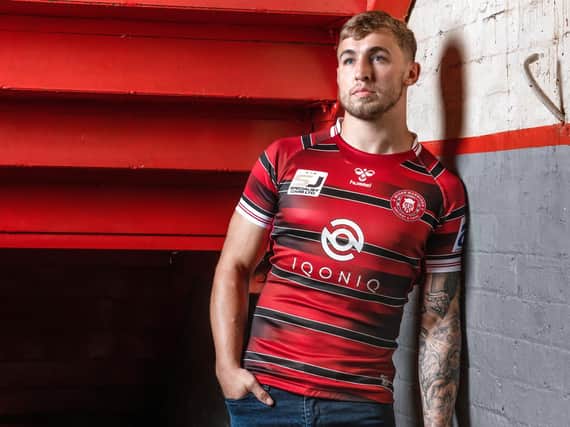 Sam Powell models the 2021 Warriors home shirt