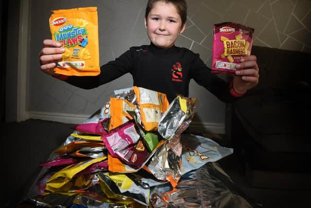 Freddie with some of his crisp packets