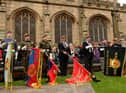 Standards are lowered during the service at Wigan Parish Church in 2010.