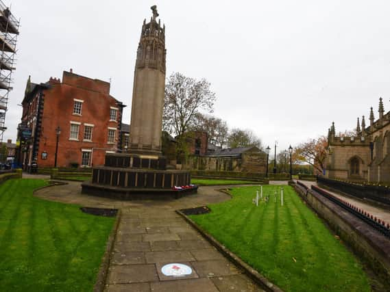 Social distancing signs have been placed on the floor at Wigan's war memorial