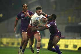 Oliver Gildart looks to break through the Huddersfield line