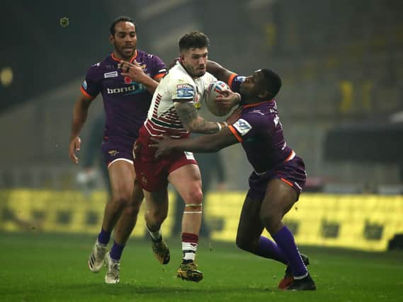 Oliver Gildart looks to break through the Huddersfield line