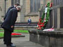 Mayor of Wigan Coun Steve Dawber and consort Oliver Waite bow in respect after laying a wreath.