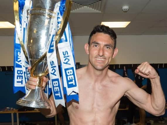 Gary Roberts celebrates winning the League One title in 2018