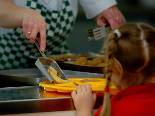 A school pupil being given a meal