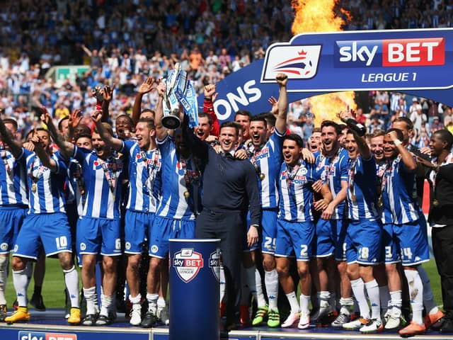 Gary Caldwell celebrates with his 2015-16 League One title winners