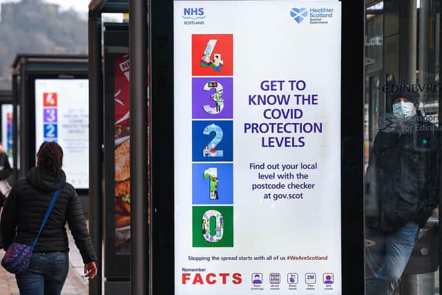 Adverts on a bus station in Edinburgh; Scotland already has a five tier system