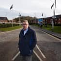 Coun Ray Whittingham stands near to the grass verge on Rectory Lane, Standish