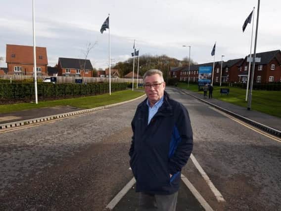 Coun Ray Whittingham stands near to the grass verge on Rectory Lane, Standish
