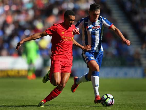 Jordan Flores in action for Latics against Liverpool