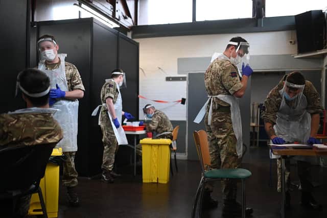 British Army soldiers, 1st battalion Coldstream Guards, staff a coronavirus testing centre set up at the Merseyside Caribbean Council Community Centre in Liverpool, north west England, on November 10, 2020 during a city-wide mass testing pilot operation