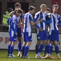 Kal Naismith is congratulated after putting Latics ahead at Lincoln