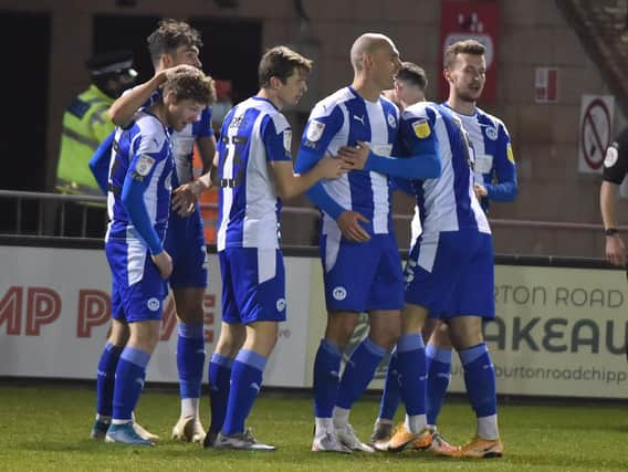 Kal Naismith is congratulated after putting Latics ahead at Lincoln