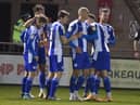 Kal Naismith is congratulated after putting Latics ahead at Lincoln