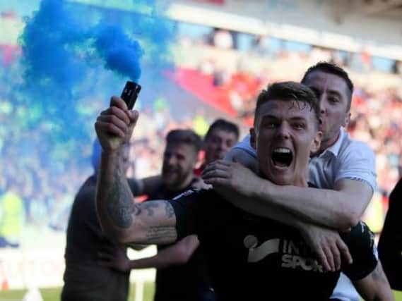 Max Power celebrates winning the League One title for a second time with Latics