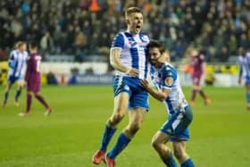 Max Power congratulates Will Grigg after scoring the goal that ruined Manchester City's quadruple dream