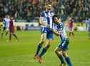 Max Power congratulates Will Grigg after scoring the goal that ruined Manchester City's quadruple dream