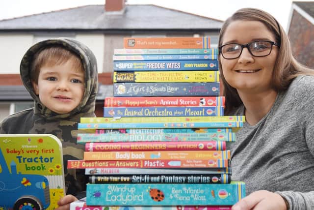 Sarah Rice with son Dillon and some of her books which she is donating to the hospital