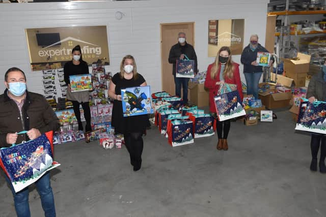 Staff from Expert Roofing and Guttering and members of the church with some of the items they will distribute