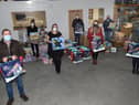 Staff from Expert Roofing and Guttering and members of the church with some of the items they will distribute