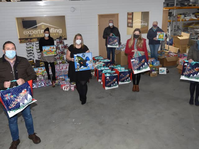Staff from Expert Roofing and Guttering and members of the church with some of the items they will distribute