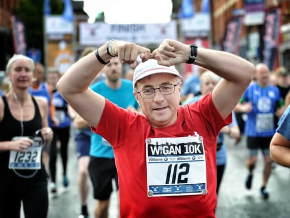 A runner does the Joining Jack salute at last year's Wigan 10k