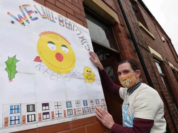 Marcus Walsh shows off a poster