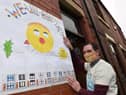 Marcus Walsh shows off a poster
