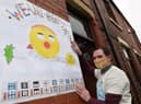 Marcus Walsh shows off a poster
