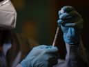 Experts say it would take almost a year to vaccinate the entire UK population against Covid-19.