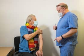 Sir Ian McKellen talking to Dr Phil Bennett-Richards as he received his Covid-19 vaccine at the Arts Research Centre, Queen Mary University Hospital, London