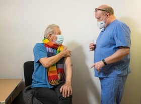 Sir Ian McKellen talking to Dr Phil Bennett-Richards as he received his Covid-19 vaccine at the Arts Research Centre, Queen Mary University Hospital, London