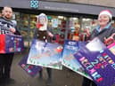 Staff at the Co-op shop in Orrell, from left, Tom Fitchett, Melissa Guy, Sue Allan and Sharon Perree, with some of the many gifts, toys and food packages they have given to families of children at Dean Trust schools