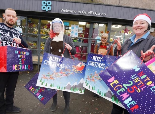 Staff at the Co-op shop in Orrell, from left, Tom Fitchett, Melissa Guy, Sue Allan and Sharon Perree, with some of the many gifts, toys and food packages they have given to families of children at Dean Trust schools