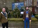 Pictured from left, are Coun Jamies Hodgkinson and James Watson, next to some of the 11 Christmas trees primary school children have decorated outside St John the Baptist's Church in Atherton town centre.