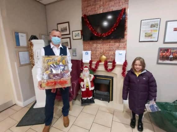 Ian Taylor, manager of Norley Hall Care home accepting the hamper from Ella-Jo Johnson, and below in the baby care unit