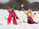 Ruby Millington (left) and Molly Chamberlain play in the snow at Tatton Park, Knutsford