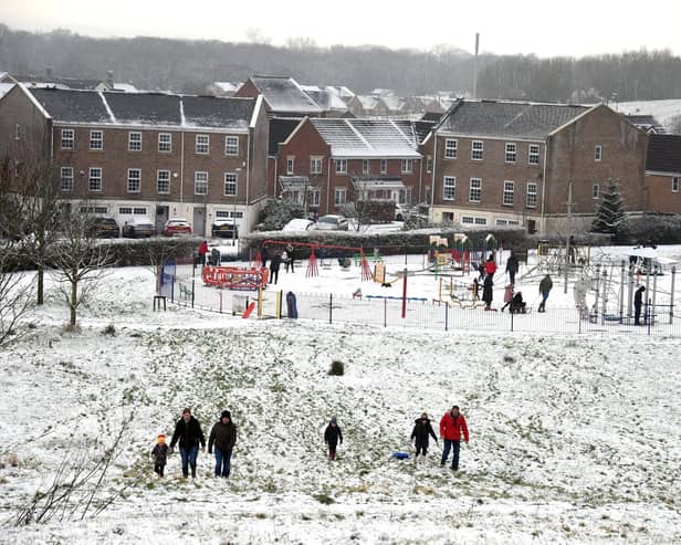 Families enjoy the snow in Buckshaw Village, near Chorley, earlier this week. North West Ambulance Service is urging people to be careful in the ice and snow after a recent spike in calls to the service
