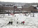 Families enjoy the snow in Buckshaw Village, near Chorley, earlier this week. North West Ambulance Service is urging people to be careful in the ice and snow after a recent spike in calls to the service