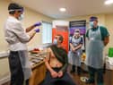 Lee Ullha receives an injection of a Covid-19 vaccine at the Depaul UK homeless shelter in Oldham, Greater Manchester