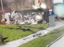 The overturned refuse wagon in Scholes