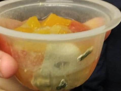Mould in a tub of fruit a Wigan parent said was in a school meals parcel