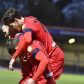 Will Keane is mobbed after his late goal which put Latics 3-2 up