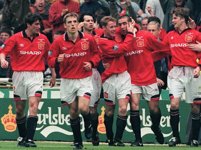 United celebrate Eric Cantona's late FA Cup final winner in 1996