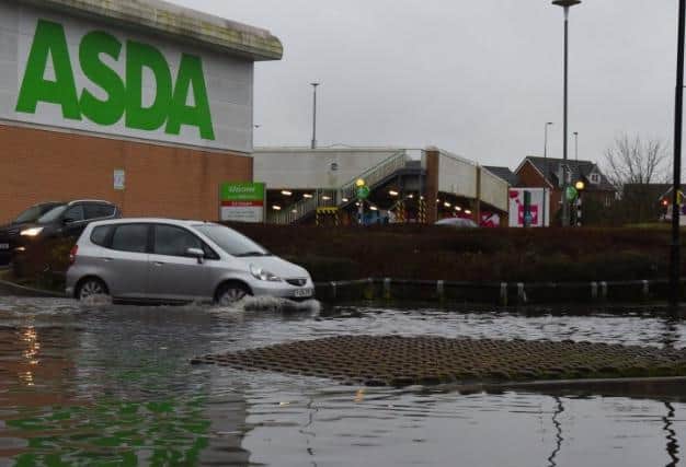 A roundabout at Asda supermarket and entrance to Robin Retail Park, Wigan, is flooded, as a weather warning is issued as Storm Christoph hits the UK.