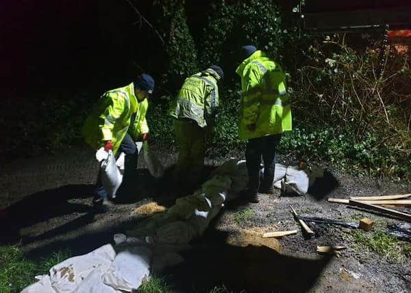 Wigan Council officers and councillors helped put sandbags into position in Platt Lane, Hindley