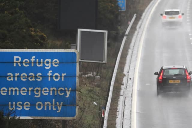 Vehicles make their way past a sign saying 'Refuge areas for emergency use only' on a smart motorway