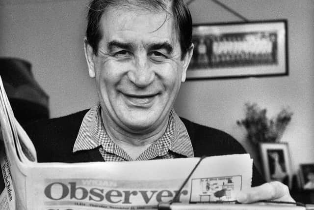 Dave Bolton reading a copy of the Wigan Observer during a trip back to his hometown in the 80s